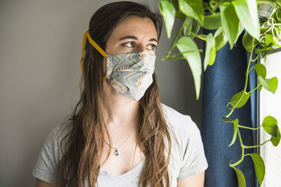 Woman indoors at home with homemade face mask protection ppe