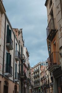 Low angle view of buildings in town against sky