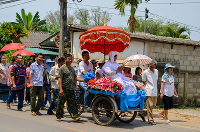 People on road against building