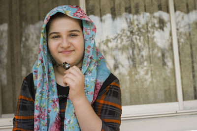 Portrait of smiling woman standing outdoors