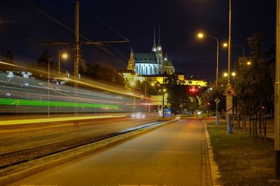 Light trails on illuminated street at night