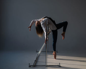 Low section of woman jumping against clear sky