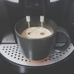 Close-up of coffee cup on espresso marker