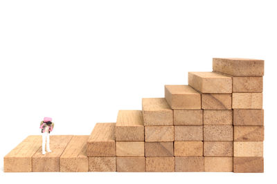 Rear view of woman standing by stack