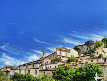 Low angle view of buildings against blue sky