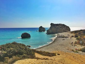 View of aphrodite rock against blue sky