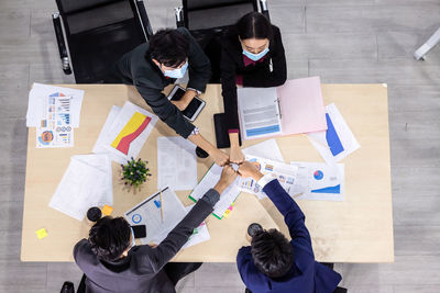 High angle view of people working on table
