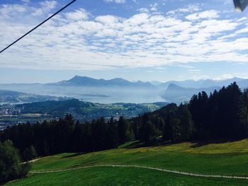 Scenic view of landscape against cloudy sky