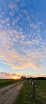 Scenic view of field against sky during sunset