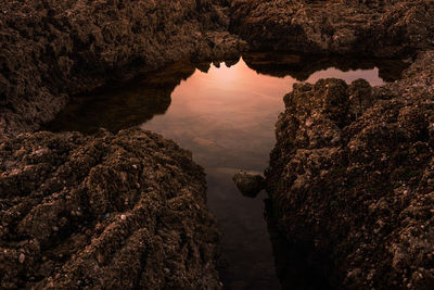 High angle view of rock formation against sky during sunset