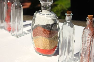 High angle view of sand variation in bottle on table