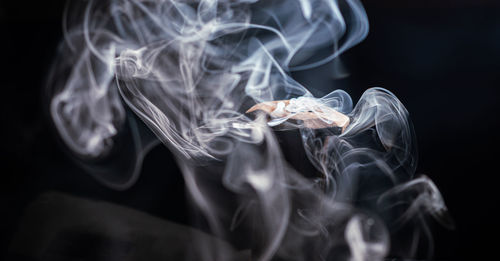 Close-up of smoke against black background