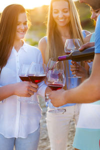 People drinking wine outdoors