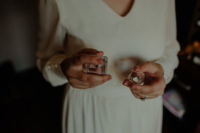 Midsection of woman holding smart phone