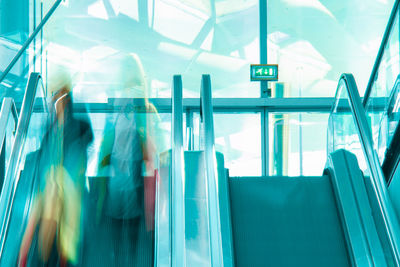 Blurred motion of people walking in modern building