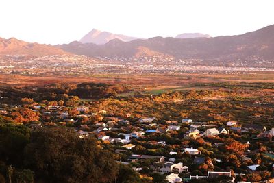 High angle view of townscape and mountains against sky