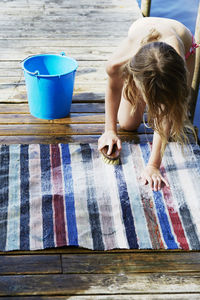 Girl cleaning rug