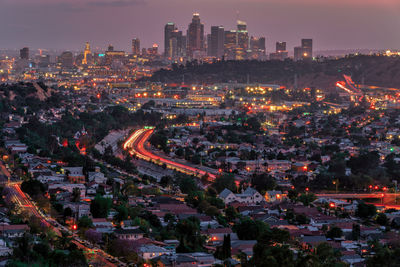 High angle view of illuminated buildings in city at dusk