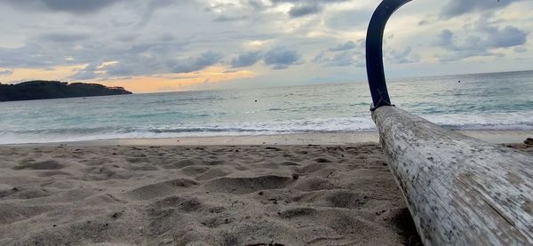 Scenic view of beach against sky during sunset