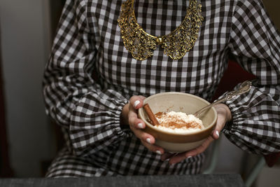 Mid section of woman holding bowl with risgrynsgröt