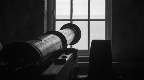 Close-up of cannon by window