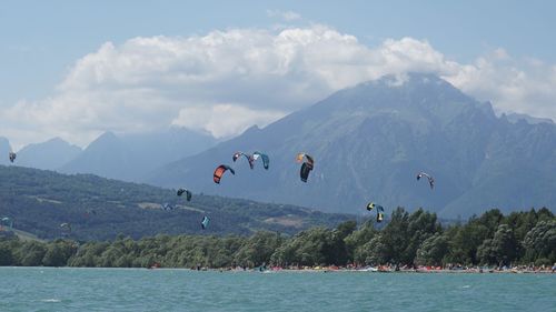 Scenic view of sea and mountains against sky santa croce lake. veneto to discover.
