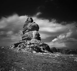 Low angle view of rock formation against sky