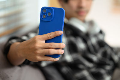 Midsection of man using mobile phone