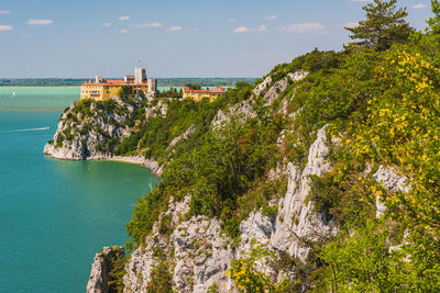 Gulf of trieste. high cliffs between boats, karst rocks and ancient castles. duino. italy