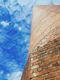 Low angle view of building against cloudy sky