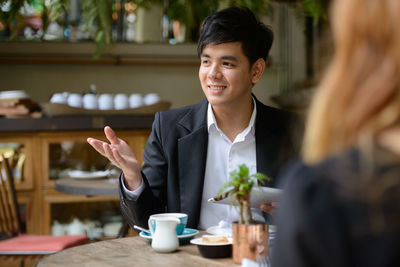 Portrait of smiling man sitting at table