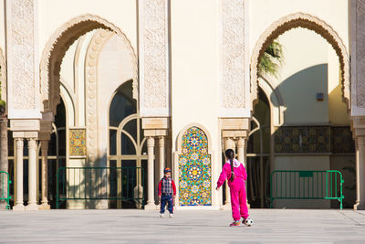 Rear view of people walking in building