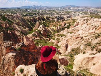 Rear view of woman wearing red hat against landscape
