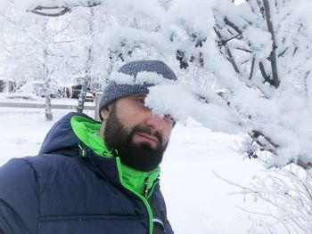 Portrait of young man in snow