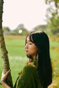 Portrait of a young woman looking down