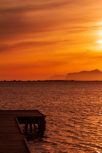 Scenic view of sea against orange sky