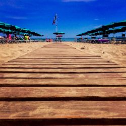 Boardwalk on beach against sky