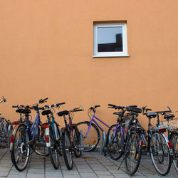 Bicycles on street by wall