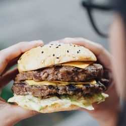 Close-up of woman holding hamburger