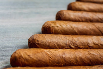 Stack of cigars in humidor on the wooden background