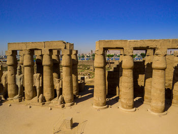 Panoramic view of old ruins against clear blue sky
