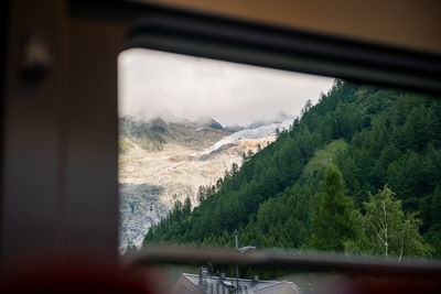 Scenic view of mountains seen through window