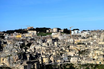 Aerial view of townscape against clear blue sky