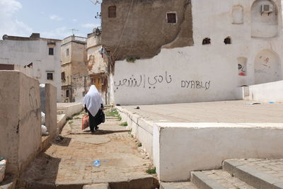 Algerian woman walking in an old part of algiers 