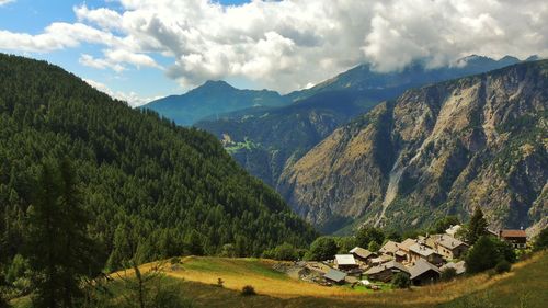 Scenic view of mountains against cloudy sky