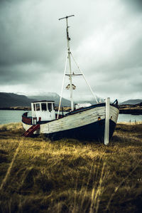 Sailboat on field against sky