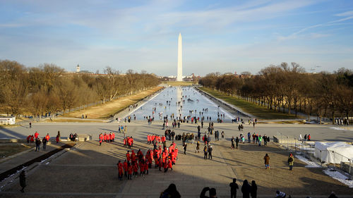 Group of chinese tourists in red cloth in front of washington monument during winter 