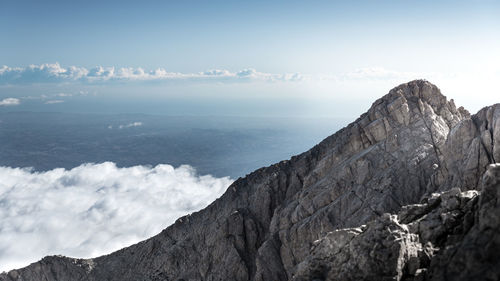 Scenic view of sea and mountains against sky