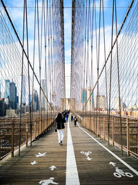 People walking on suspension bridge