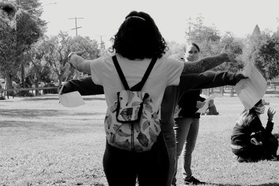 Rear view of girl standing on field